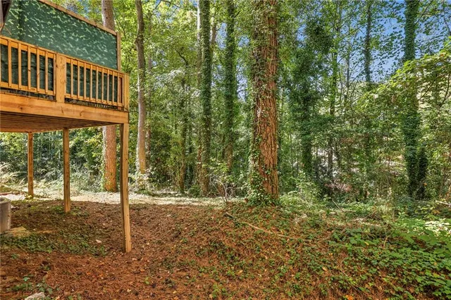 a view of a house with backyard and trees