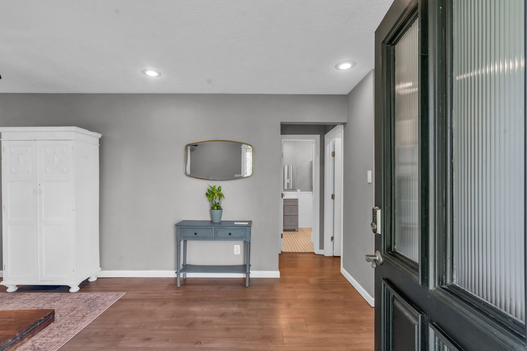 17821 Brown Road Conroe, TX 77306 - Photo 42 of 50 a view of a hallway with wooden floor cabinet and a mirror