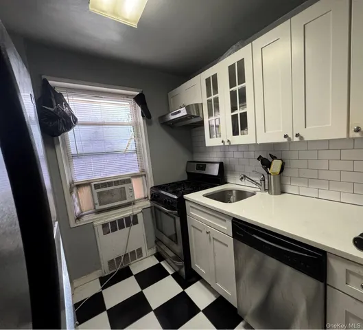 a kitchen with a stove a sink and a refrigerator