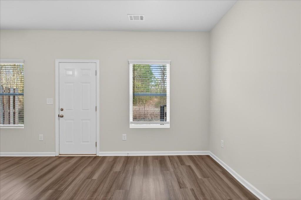 107 Brexley Drive Calhoun, GA 30701 - Photo 16 of 36 an empty room with wooden floor and windows