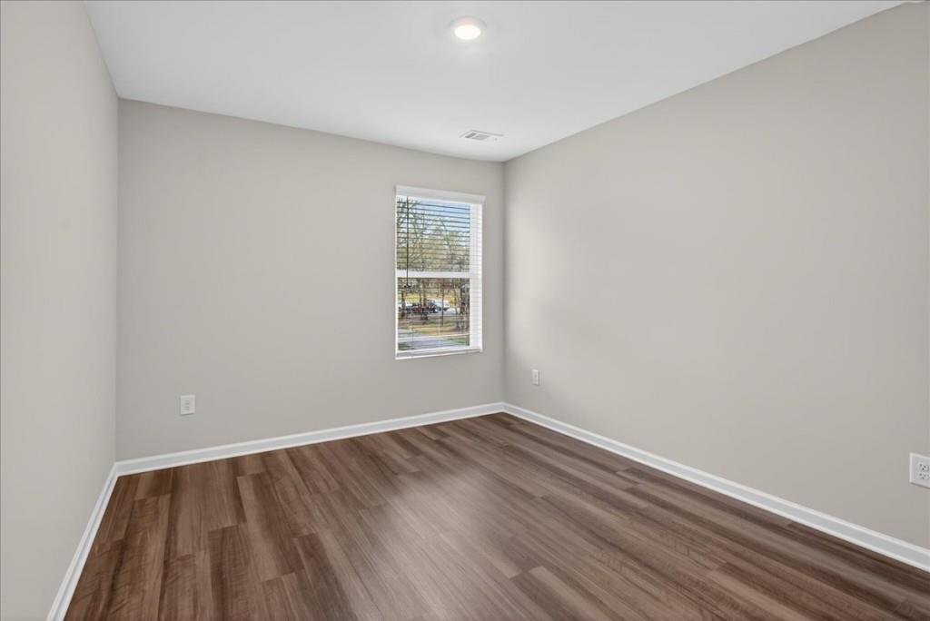 107 Brexley Drive Calhoun, GA 30701 - Photo 29 of 36 wooden floor in an empty room with a window