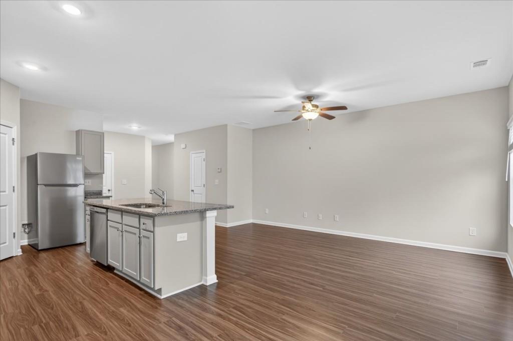 107 Brexley Drive Calhoun, GA 30701 - Photo 5 of 36 a view of kitchen with stainless steel appliances cabinets and wooden floor