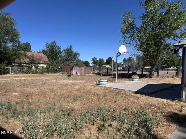 a view of a park with bench and trees