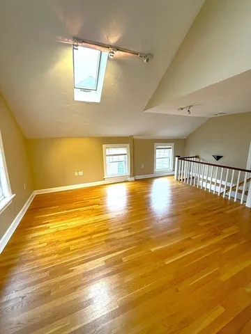 a view of an empty room and wooden floor