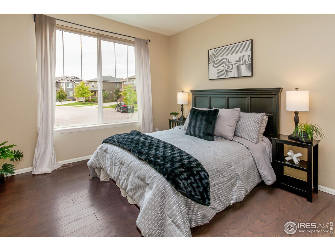 2002 Yearling Drive Fort Collins, CO 80525 - Photo 11 of 40 a bedroom with a bed and wooden floor
