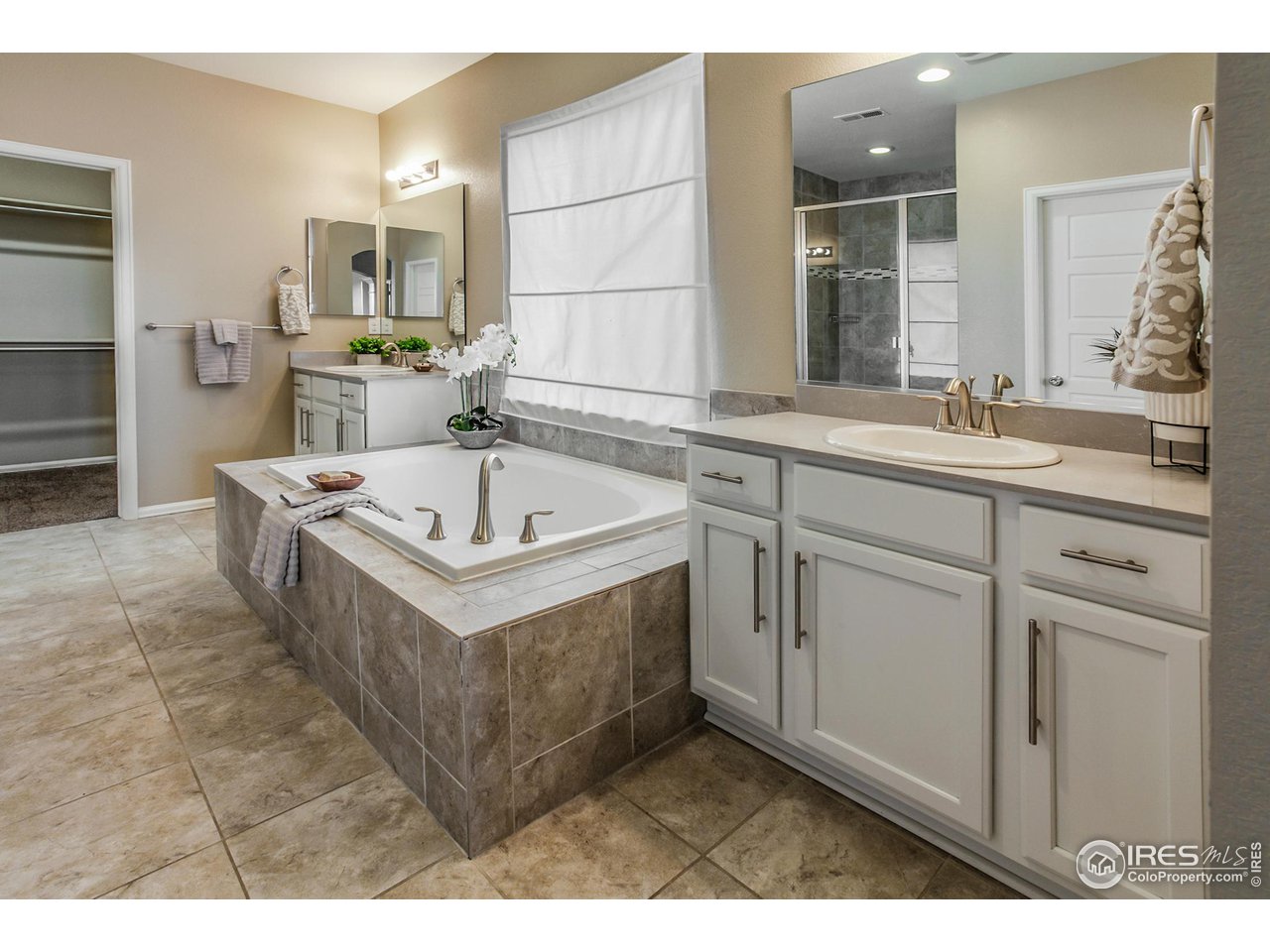 2002 Yearling Drive Fort Collins, CO 80525 - Photo 17 of 40 a spacious bathroom with a sink double vanity and a mirror
