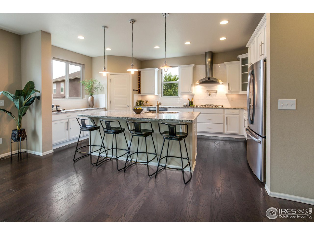 2002 Yearling Drive Fort Collins, CO 80525 - Photo 8 of 40 a kitchen with stainless steel appliances a dining table chairs and wooden floor