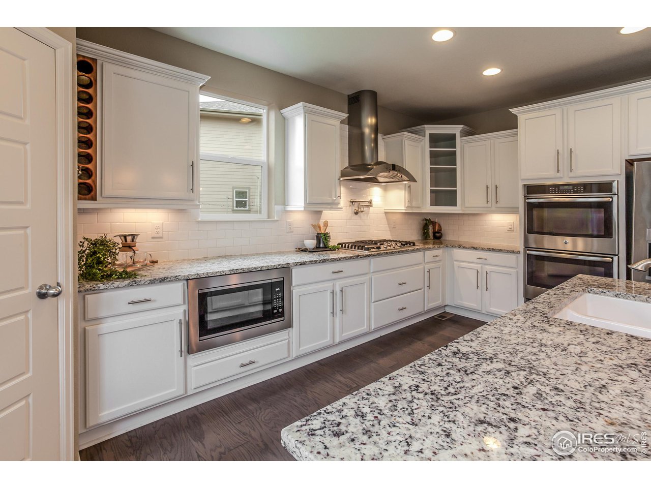 2002 Yearling Drive Fort Collins, CO 80525 - Photo 9 of 40 a kitchen with stainless steel appliances kitchen island granite countertop a sink a stove and cabinets