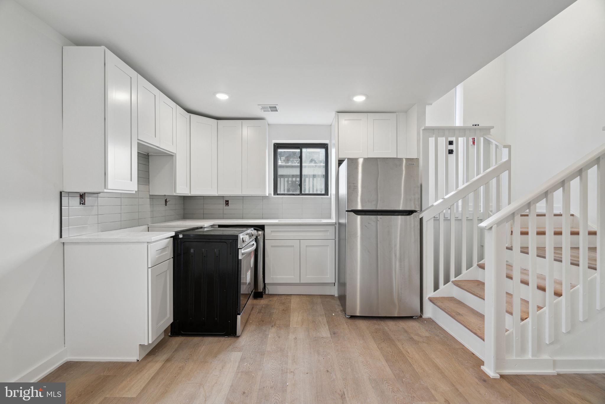 1873 Frankford Avenue, Unit 3F Philadelphia, PA 19125 - Photo 2 of 14 a kitchen with a refrigerator and white cabinets