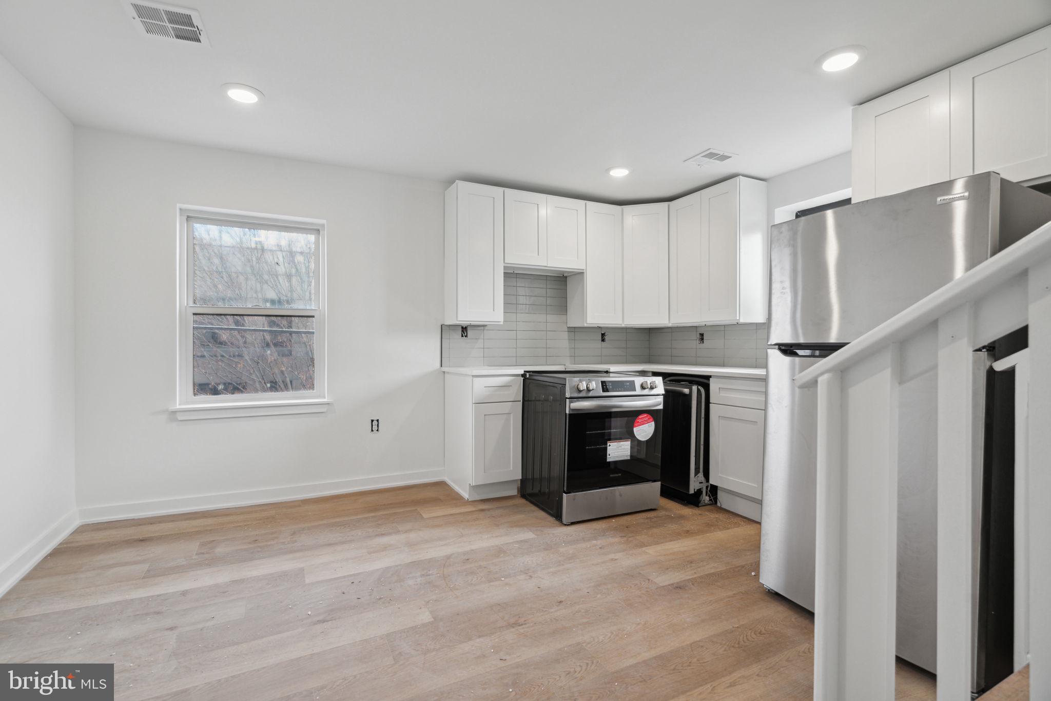 1873 Frankford Avenue, Unit 3F Philadelphia, PA 19125 - Photo 3 of 14 a kitchen with stainless steel appliances granite countertop a refrigerator and a sink