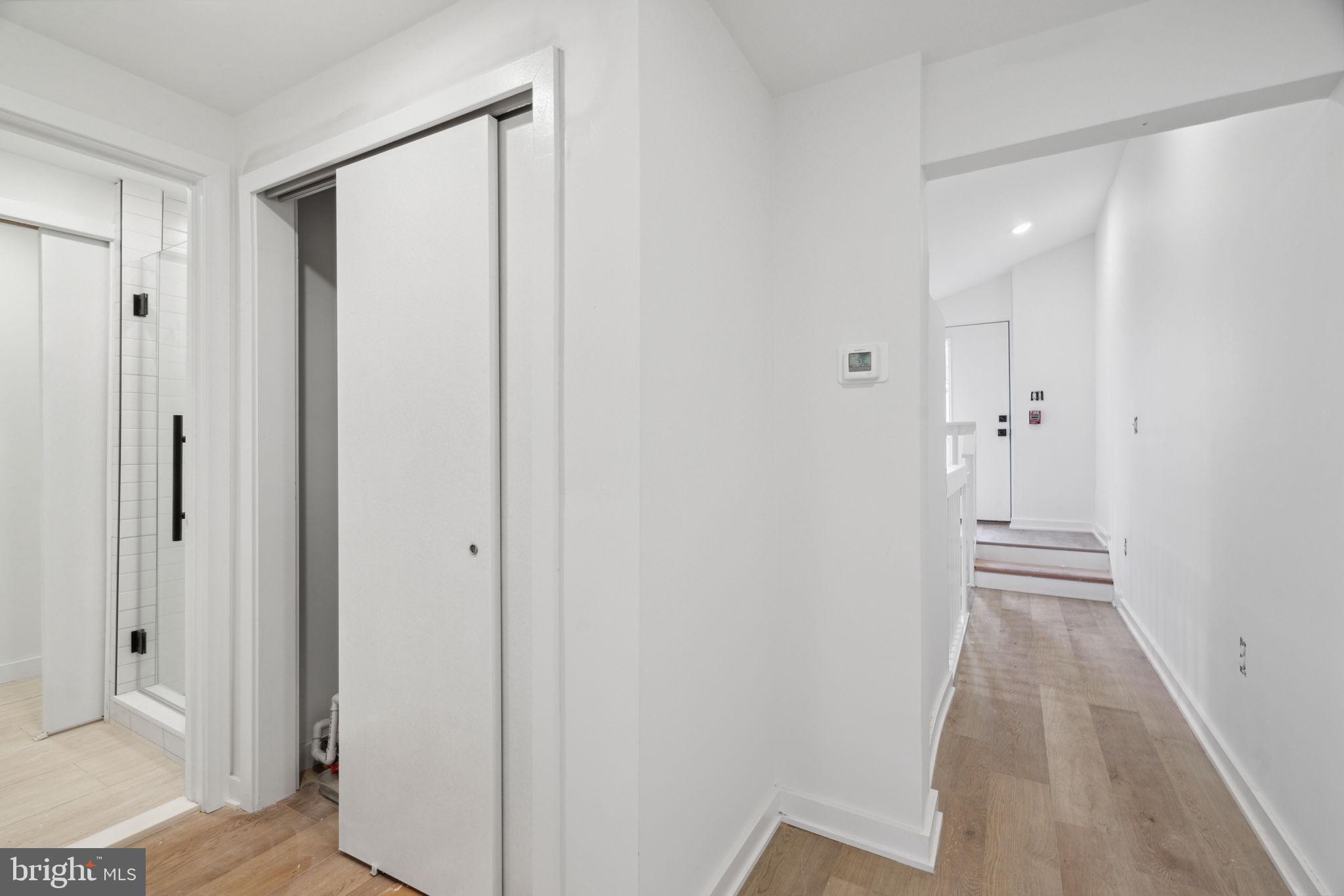 1873 Frankford Avenue, Unit 3F Philadelphia, PA 19125 - Photo 8 of 14 a view of a hallway with wooden floor and a bathroom