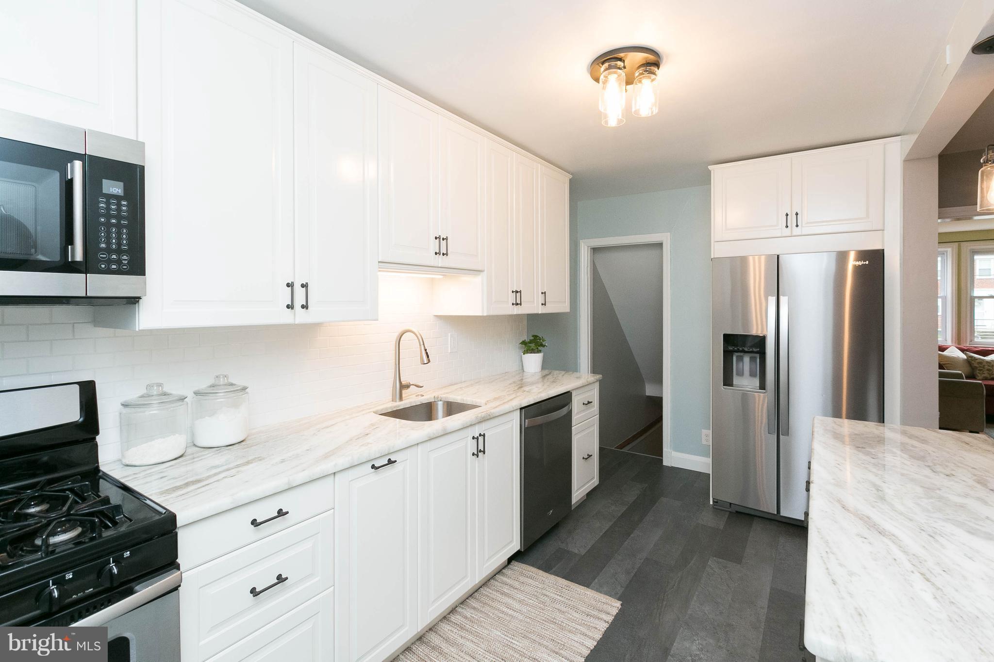 344 Greenlow Road Baltimore, MD 21228 - Photo 13 of 27 a kitchen with a sink stove and refrigerator