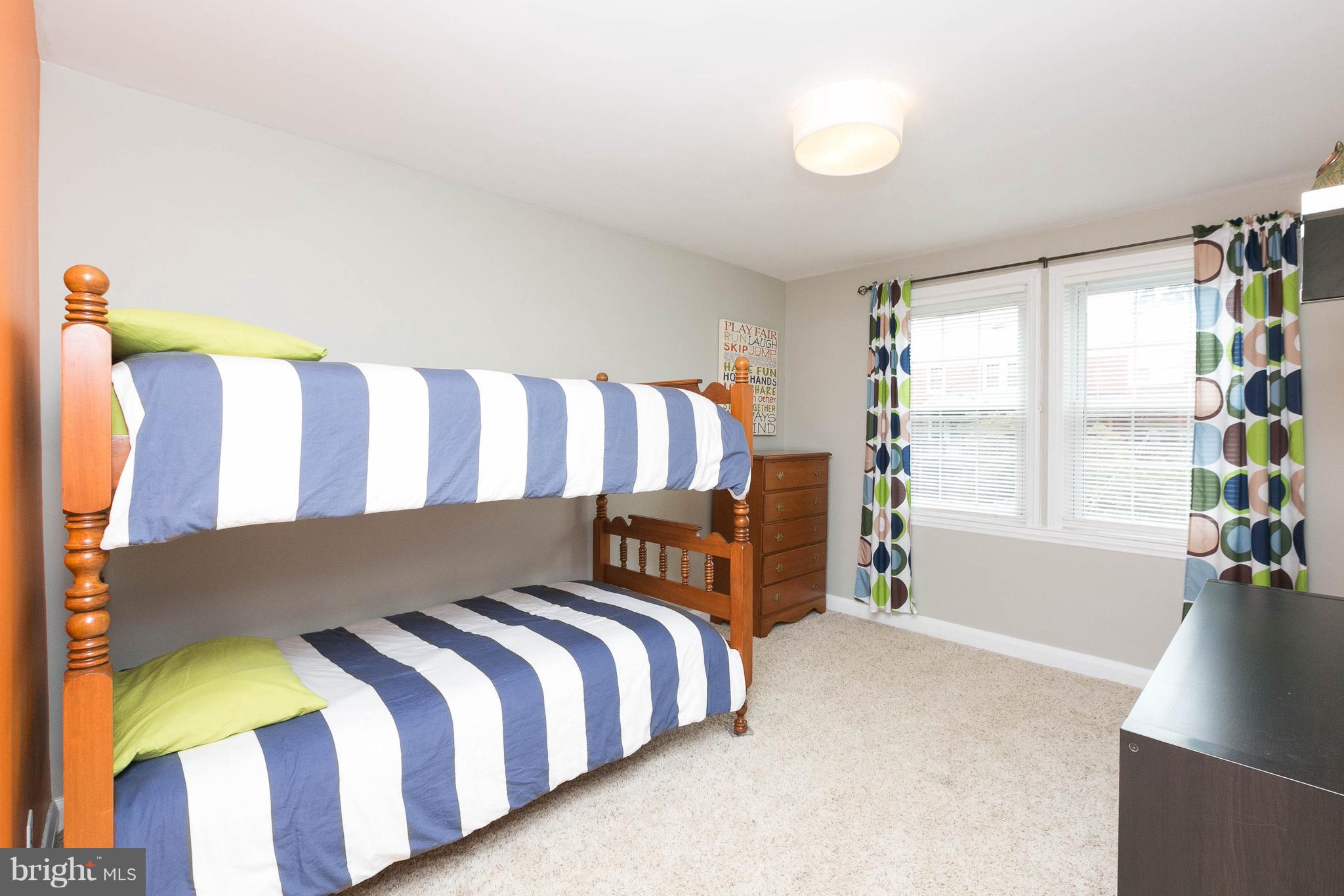 344 Greenlow Road Baltimore, MD 21228 - Photo 18 of 27 a spacious bedroom with a bed and a large window