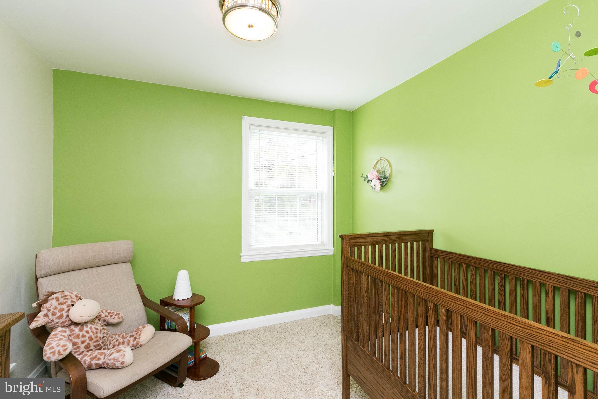 344 Greenlow Road Baltimore, MD 21228 - Photo 20 of 27 a bedroom with a bed and wooden floor