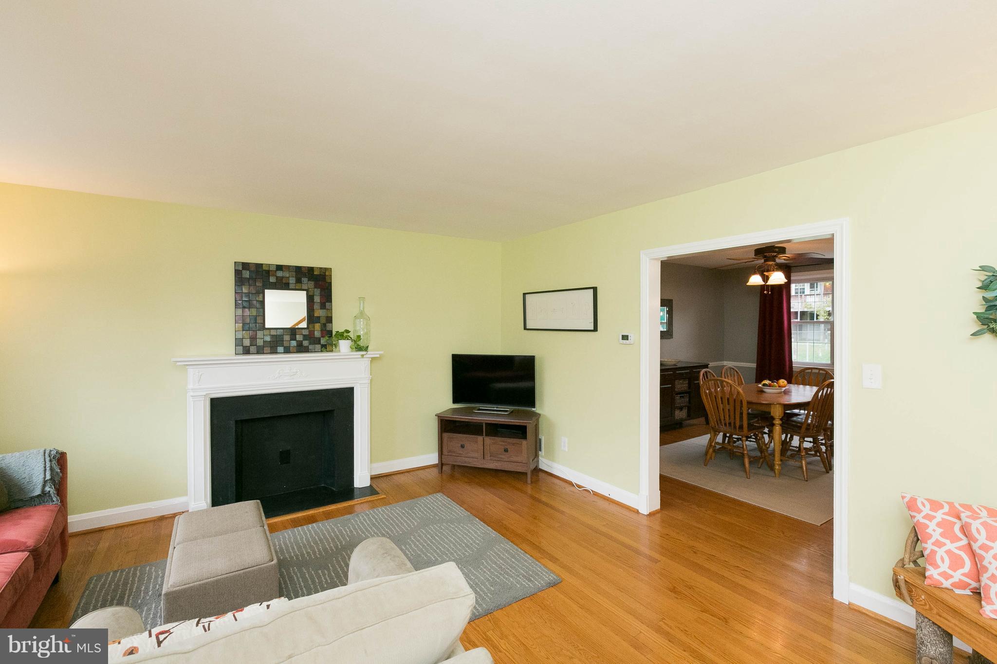 344 Greenlow Road Baltimore, MD 21228 - Photo 3 of 27 a living room with furniture a fireplace and a flat screen tv