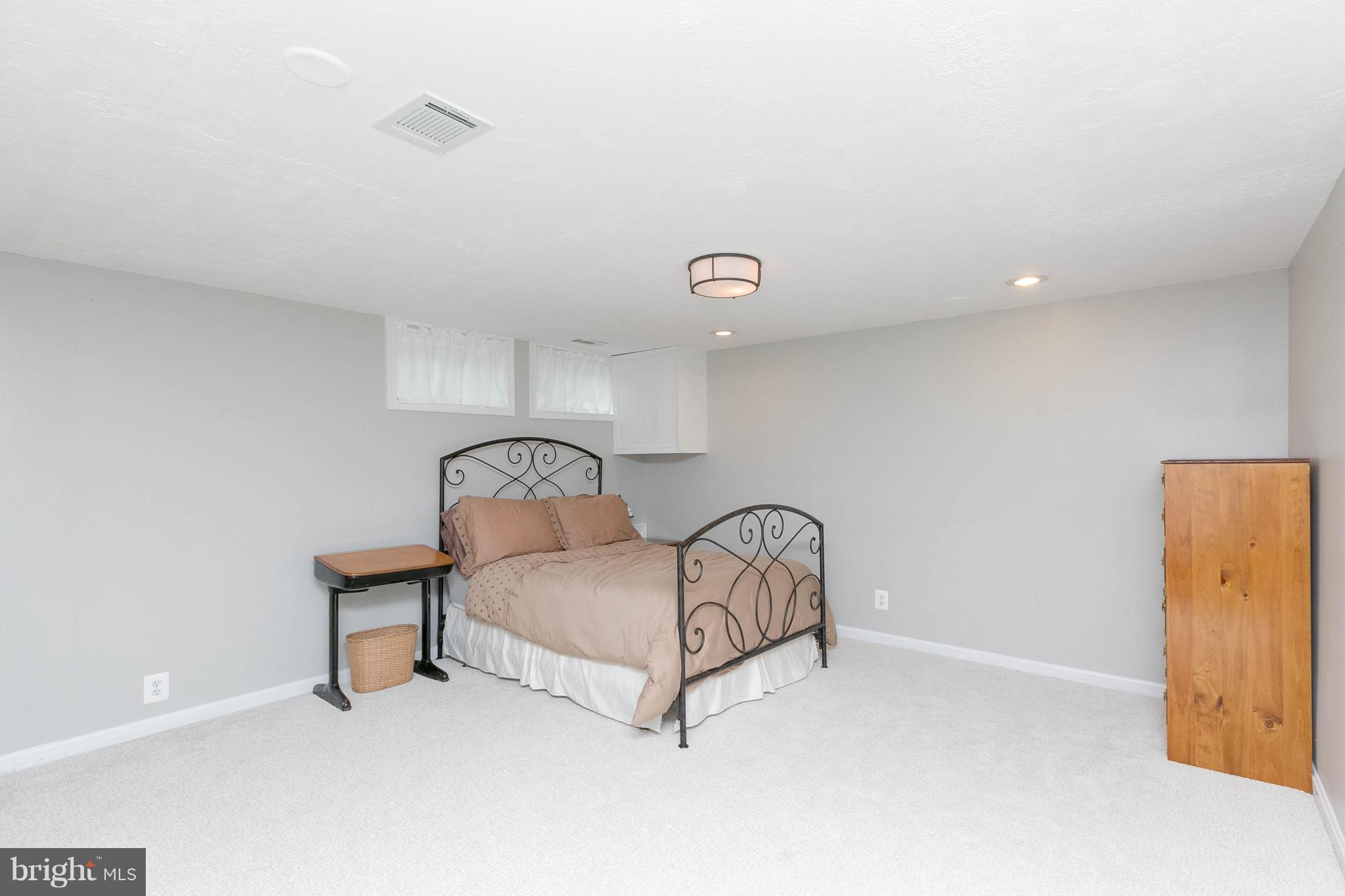 344 Greenlow Road Baltimore, MD 21228 - Photo 23 of 27 a bed room with a bed and a lamp