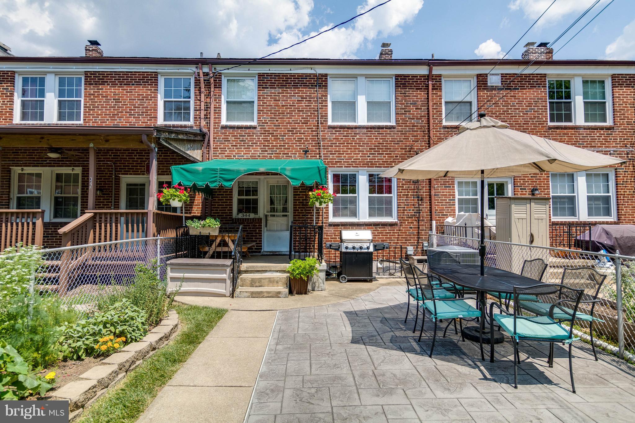 344 Greenlow Road Baltimore, MD 21228 - Photo 25 of 27 a view of a brick building with a bench in patio