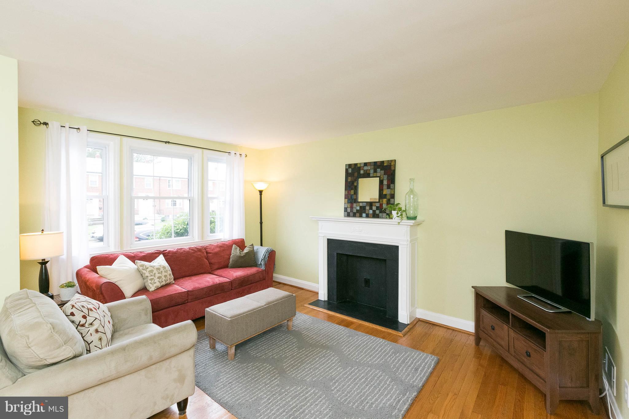 344 Greenlow Road Baltimore, MD 21228 - Photo 5 of 27 a living room with furniture a flat screen tv and a fireplace