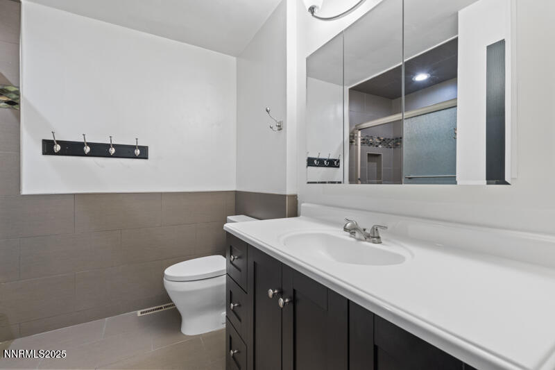 850 West 11th Street Reno, NV 89503 - Photo 23 of 31 a bathroom with a sink a toilet and mirror