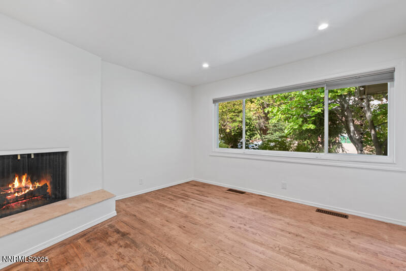 850 West 11th Street Reno, NV 89503 - Photo 6 of 31 a view of empty room with wooden floor and fireplace