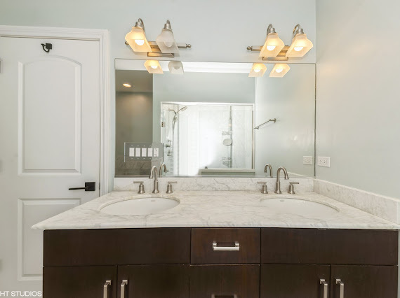 1347 West Fillmore Street, Unit A1 Chicago, IL 60607 - Photo 11 of 21 a bathroom with a sink and a mirror