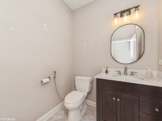 1347 West Fillmore Street, Unit A1 Chicago, IL 60607 - Photo 13 of 21 a bathroom with a toilet sink and mirror