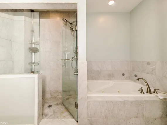 a bathroom with a bathtub and shower