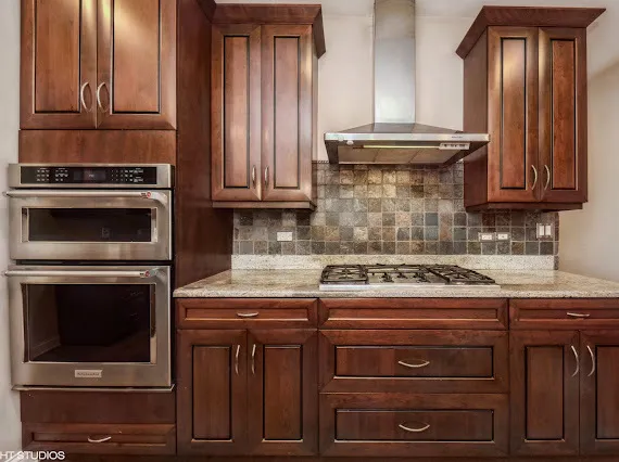 a stove top oven sitting inside of a kitchen