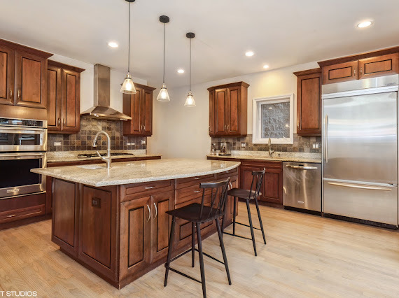 1347 West Fillmore Street, Unit A1 Chicago, IL 60607 - Photo 5 of 21 a kitchen with stainless steel appliances granite countertop a stove a sink dishwasher a refrigerator and a oven with wooden floor