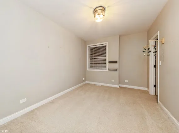 an empty room with windows and closet
