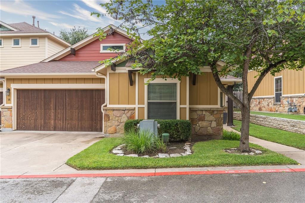 6708 Menchaca Road, Unit 14 Austin, TX 78745 - Photo 1 of 22 Exterior featuring a wood-finish garage door, stone accents, and a complementary color palette
