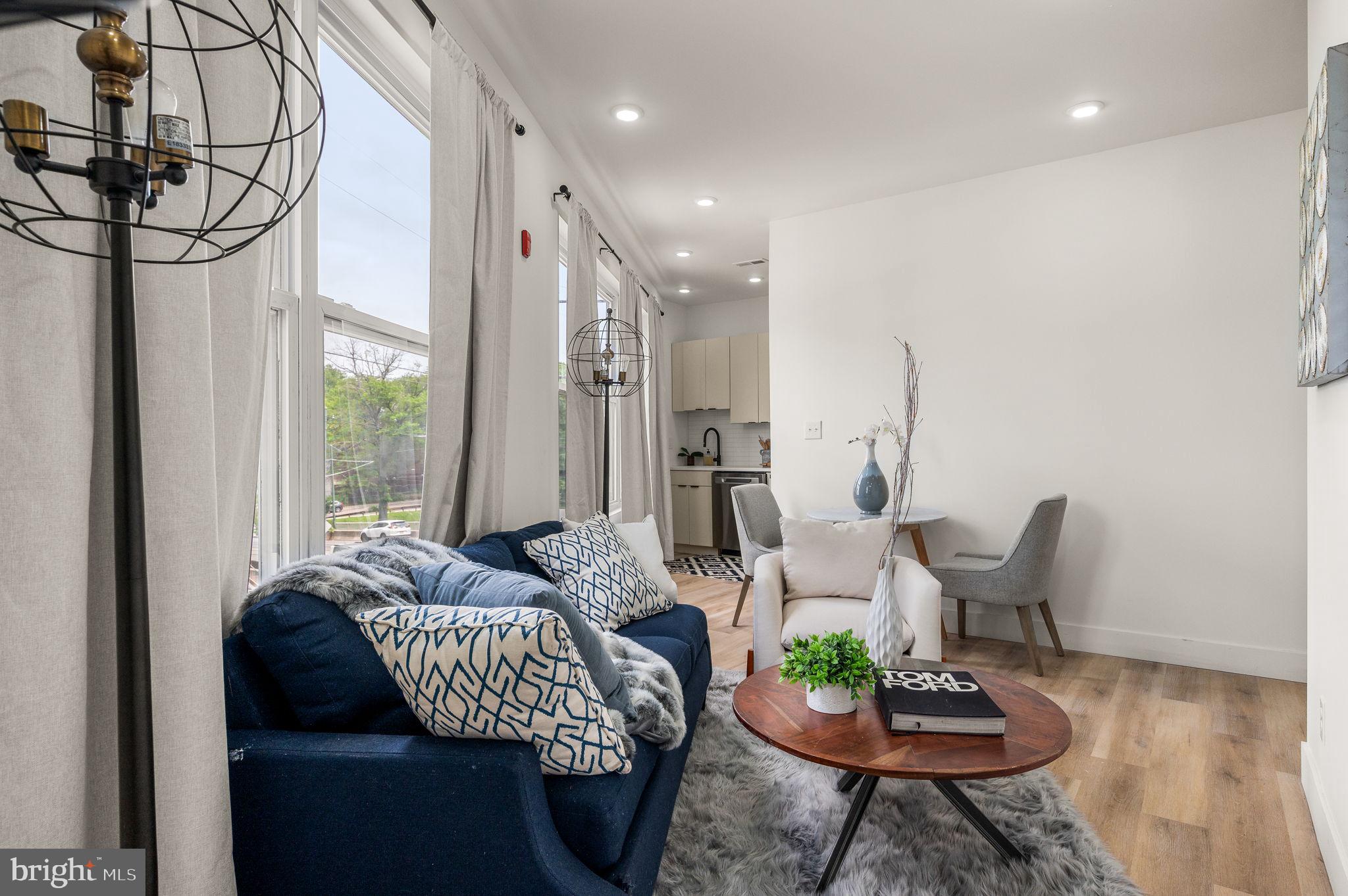 4921 Chester Avenue, Unit 2O2 Philadelphia, PA 19143 - Photo 5 of 10 a living room with furniture and a large window