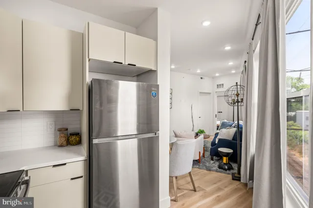 a kitchen with stainless steel appliances granite countertop a refrigerator and a stove top oven