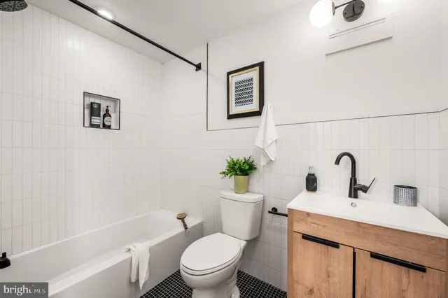 a bathroom with a sink mirror vanity and toilet