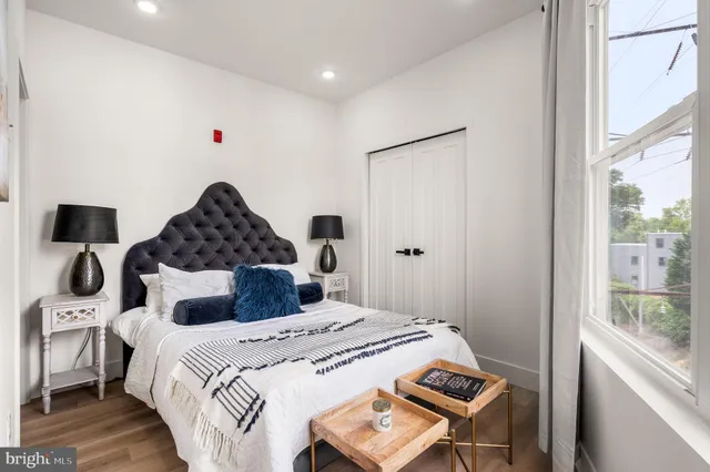 a bedroom with a bed and a window