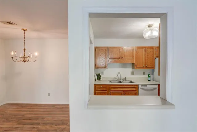 a view of a dining room with furniture wooden floor and a chandelier