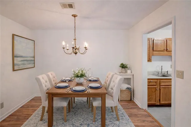 a view of a room with wooden floor and ceiling fan