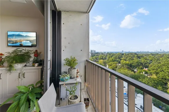 a city view from a balcony with wooden floor