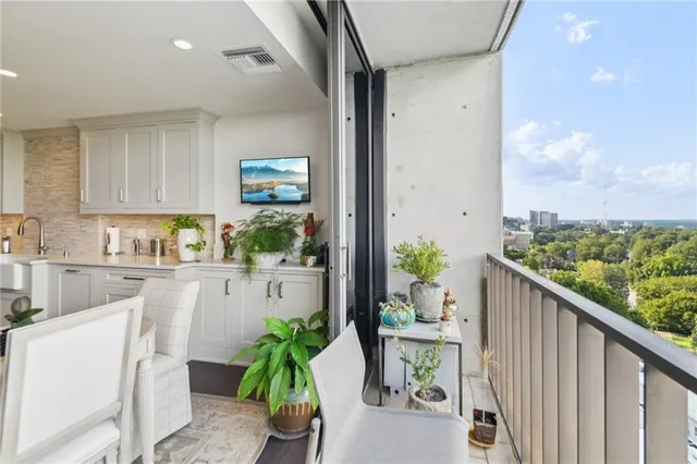 a open kitchen with white cabinets and wooden floor