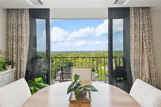 a balcony with furniture and a potted plant