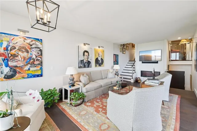 a living room with fireplace furniture and flat screen tv