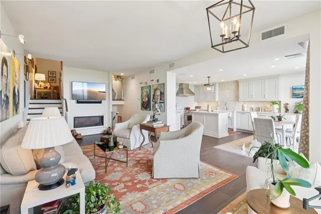 a living room with furniture and kitchen view