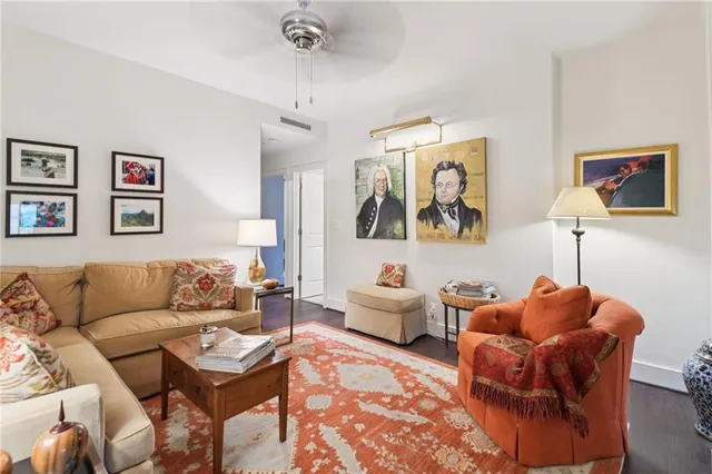 a living room with furniture kitchen view and a window