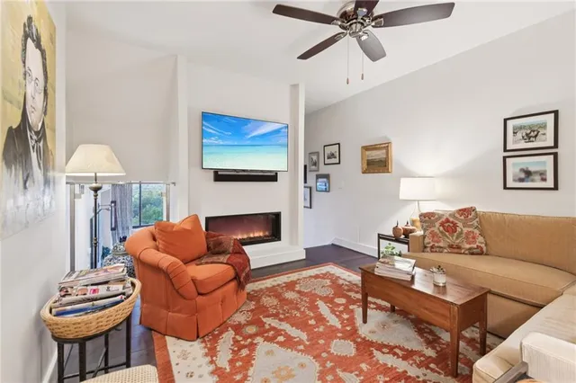a living room with furniture a rug and a fireplace