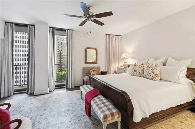 a spacious bedroom with a bed and a chandelier