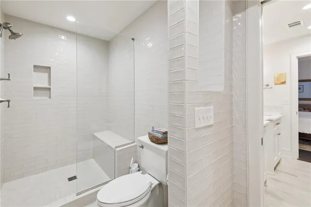 a white toilet sitting next to a bath tub shower