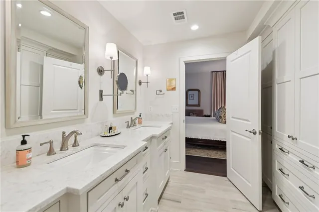 a spacious bathroom with a granite countertop sink and a mirror