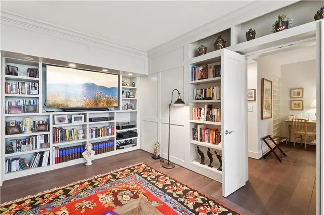 a living room with lots of books and a book shelf