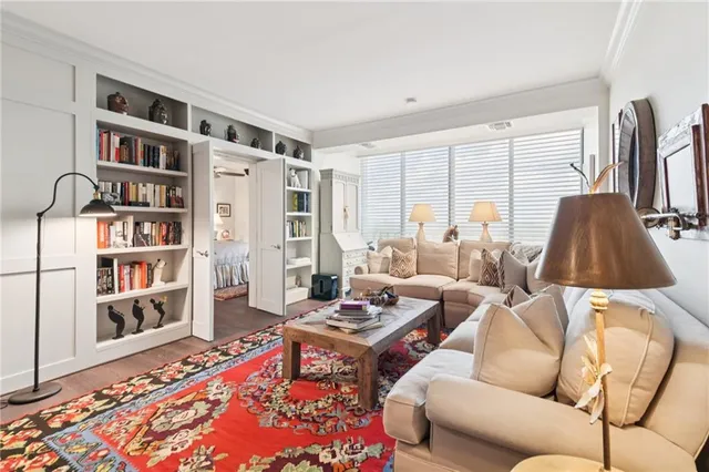 a living room with furniture and a book shelf