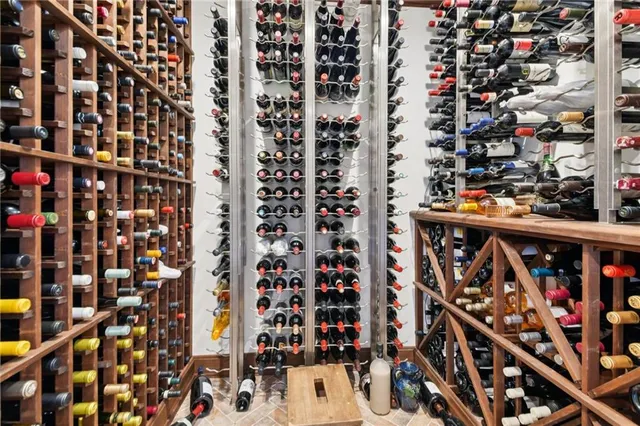 a large bedroom with a large bed and large windows